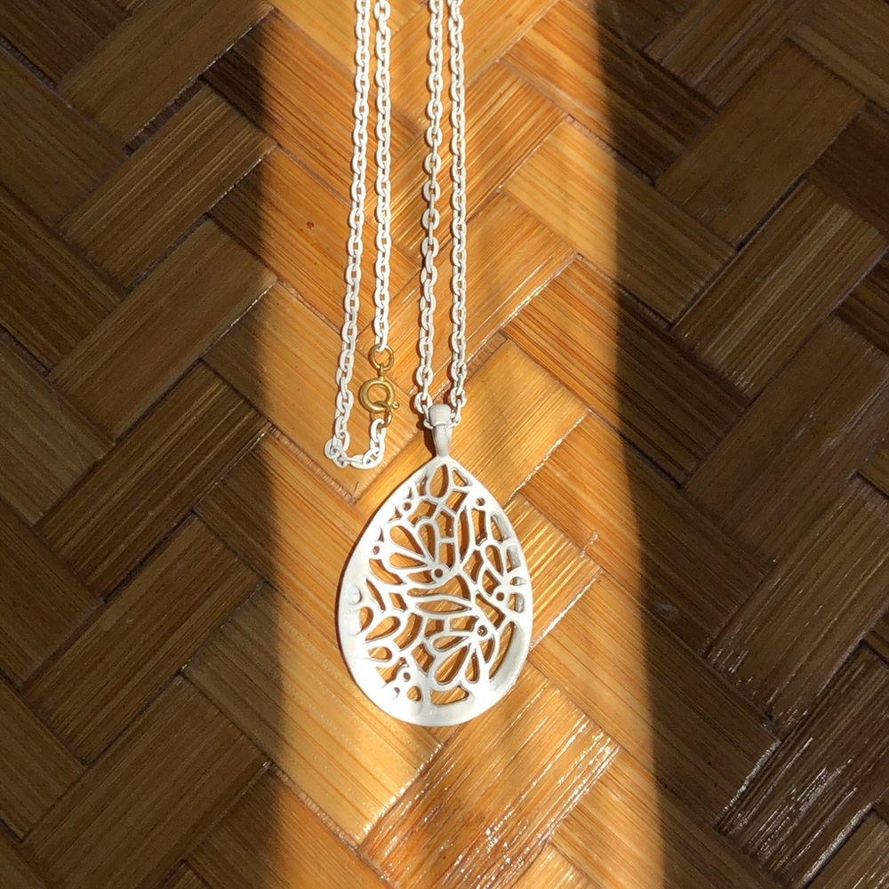 White metal open work pendant necklace